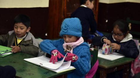 Niños asisten a su unidad educativa abrigados en la época de invierno