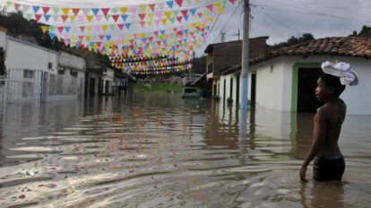 Un niño camina por una calle hoy inundada en Cali como consecuencia del fenómeno climatológico de La Niña