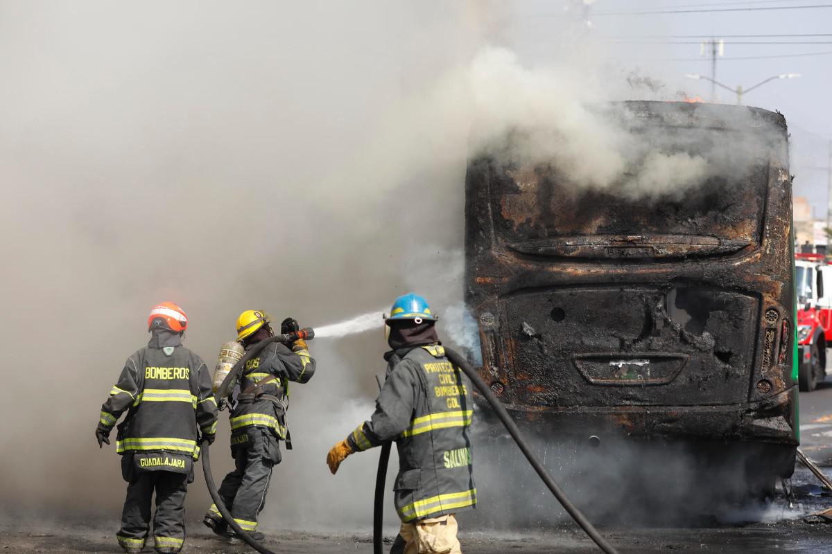 Bomberos apagando un vehículo incendiado en México