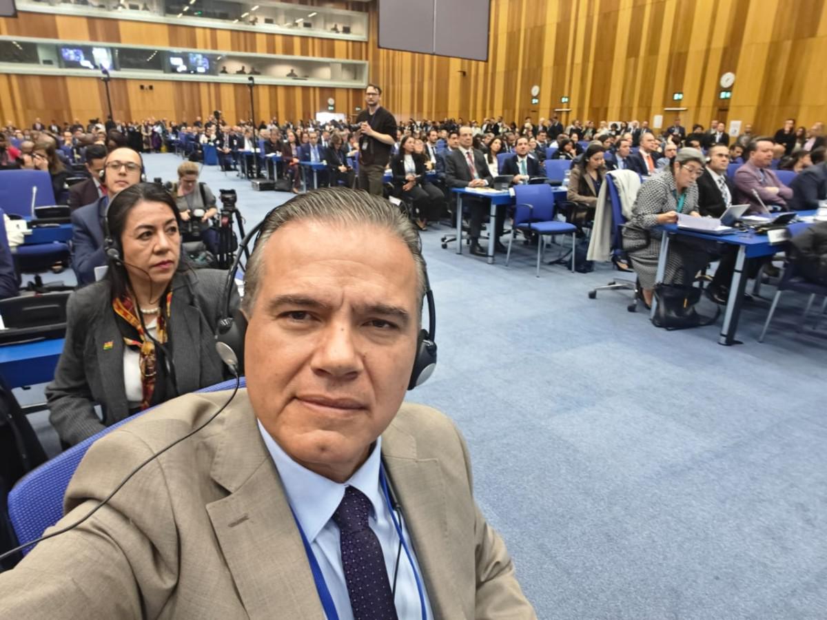 un señor en un salón con varias personas