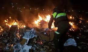 Policias quemando los billetes botados tras accidente aereo