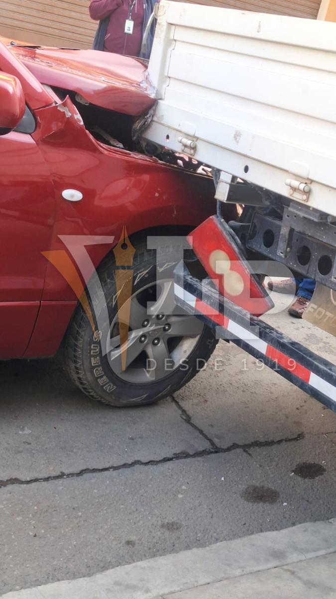 Vagoneta Suzuki incrustada bajo la parte trasera de un camión