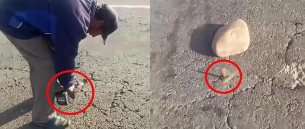 Un  persona utiliza un taladro industrial para perforar la capa asfáltica