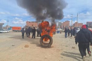 Incendio de un neumático y un grupo de personas