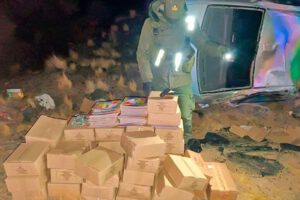 Un agente de seguridad examina el cargamento de álbumes y figuritas del Mundial 2026 hallado tras el accidente vehicular