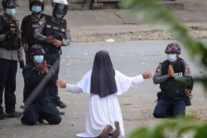 Monja se arrodilla ante policías en Birmania
