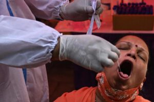 Un trabajador sanitario toma una muestra a una mujer para un test de coronavirus en India