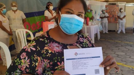 Mujer cruceña con su carnet de vacunación contra el Covid-19