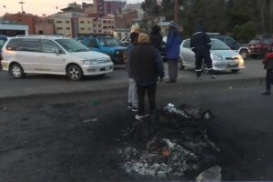 Personas paradas y autos