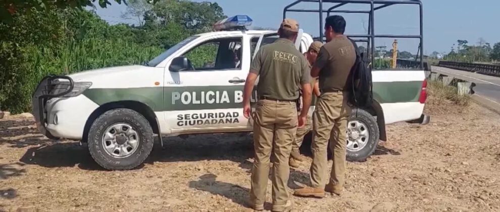 Dos personas y un auto de policia