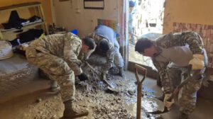 Militares sacando lodo de una vivienda